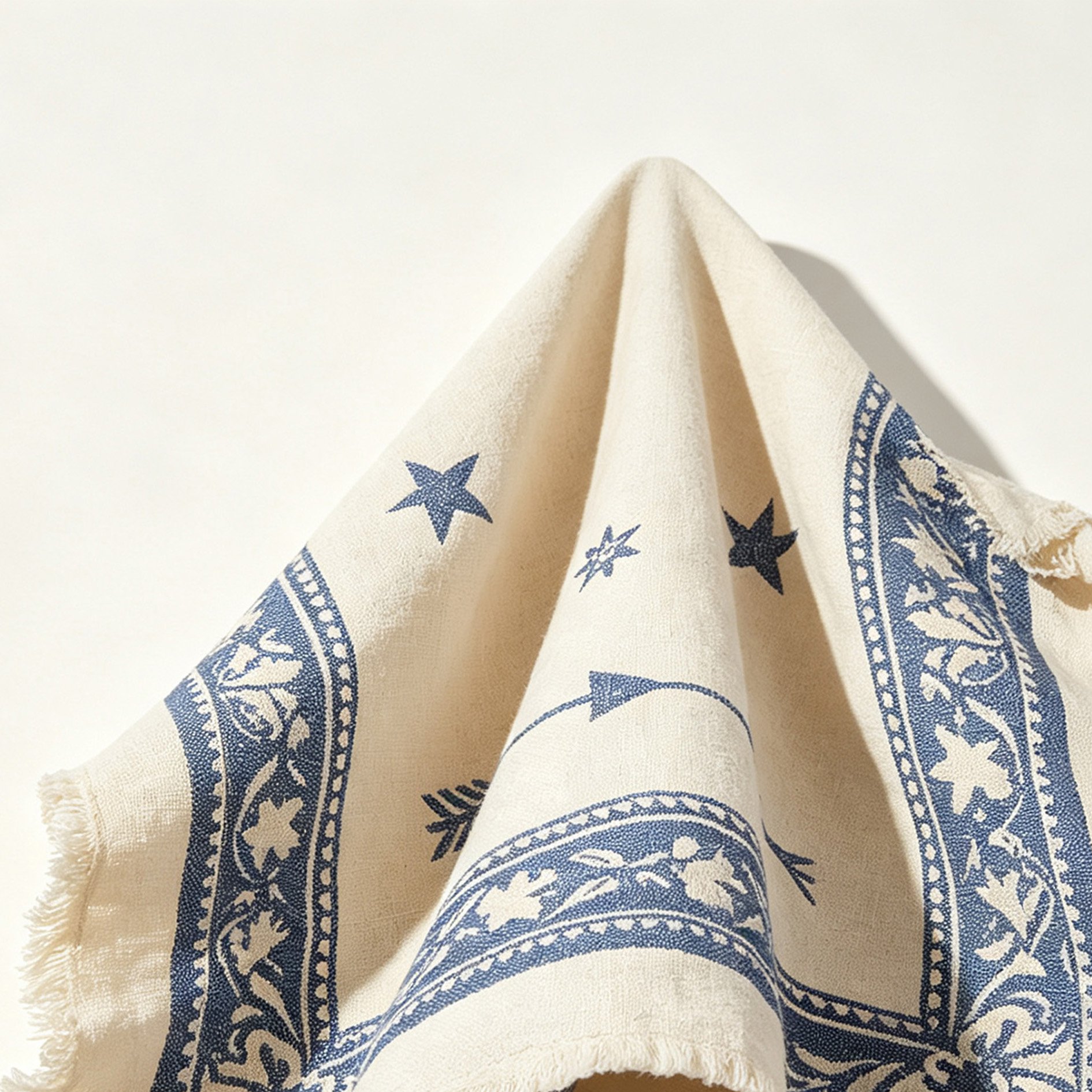 Blue printed tassel tea towel displayed in kitchen
