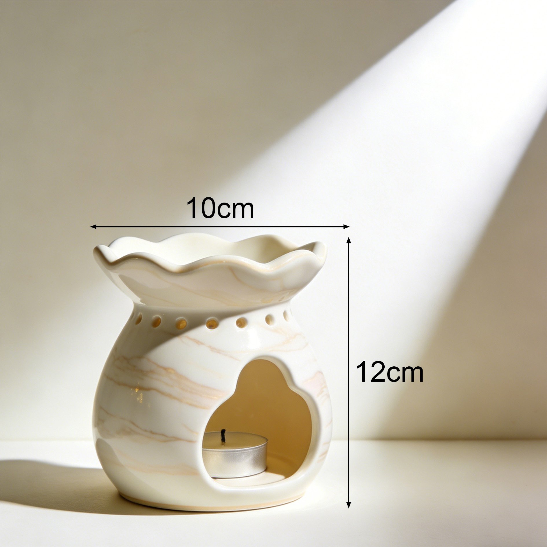 Close-up of ceramic oil burner with floral design