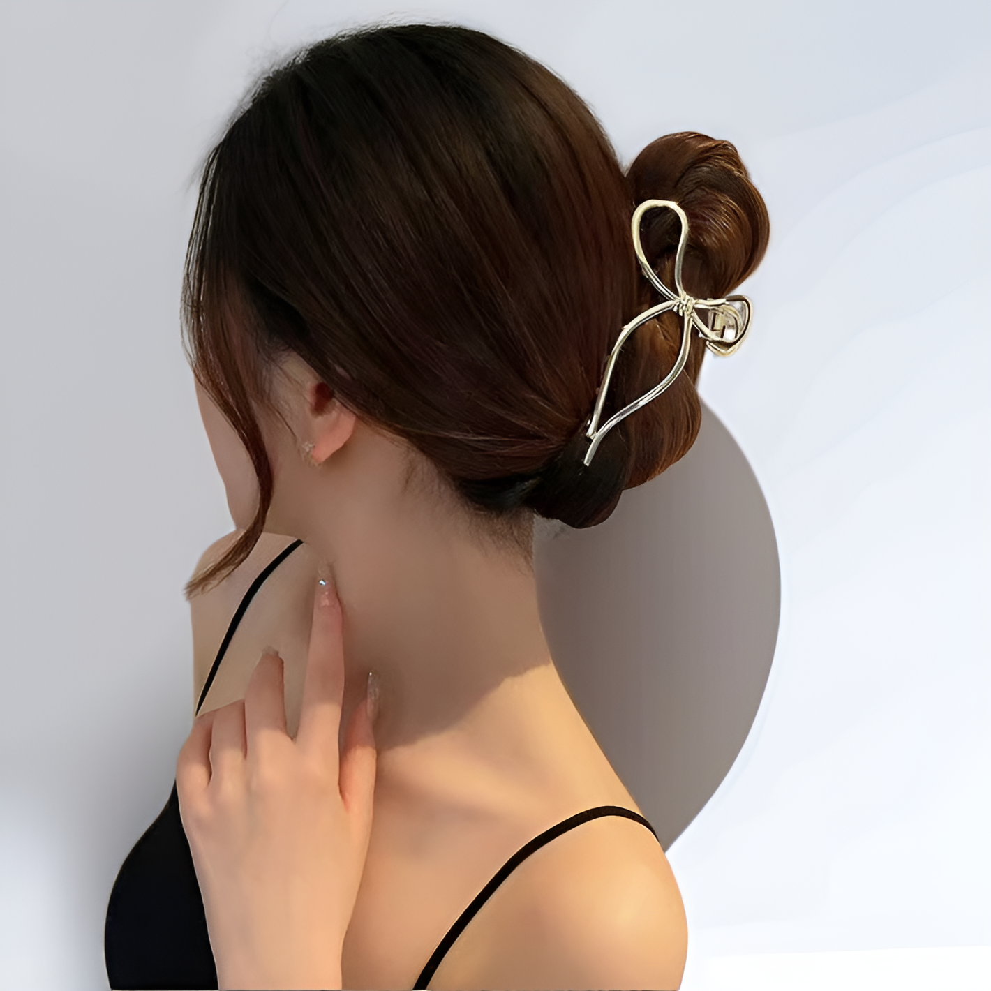 Hair at the back of the head is clamped with a bow metal clip