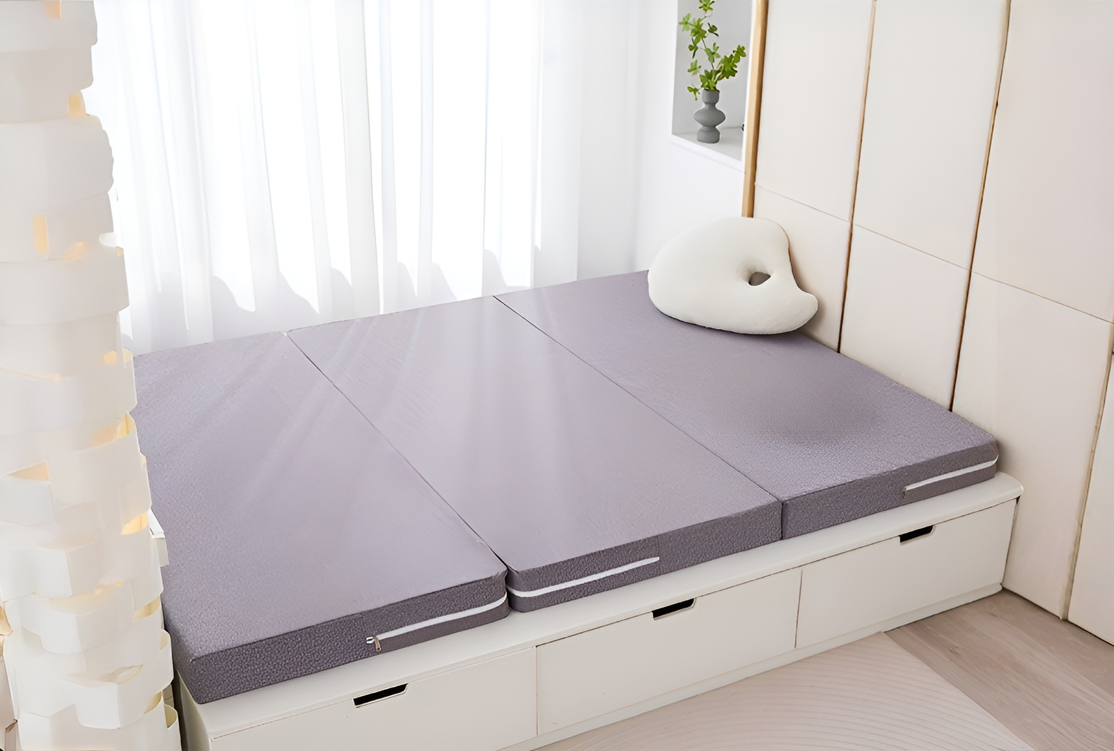 Comfortable Japanese-style floor bed setup with folding mattress