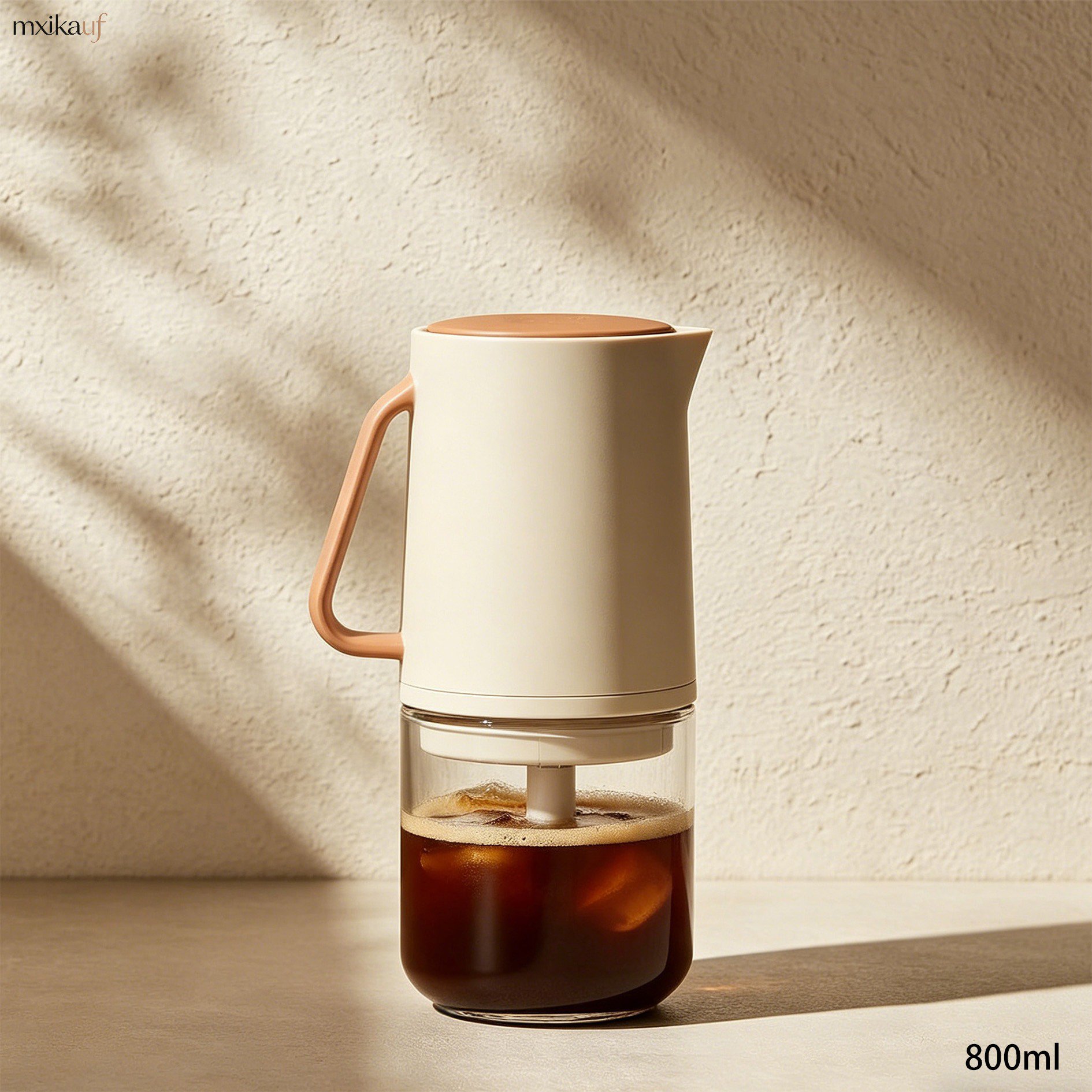 Pouring cold brew from coffee maker into glass