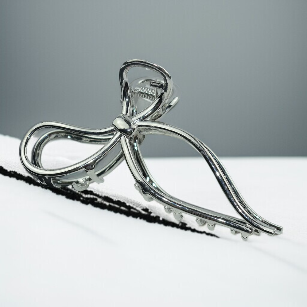 Hair at the back of the head is clamped with a bow metal clip