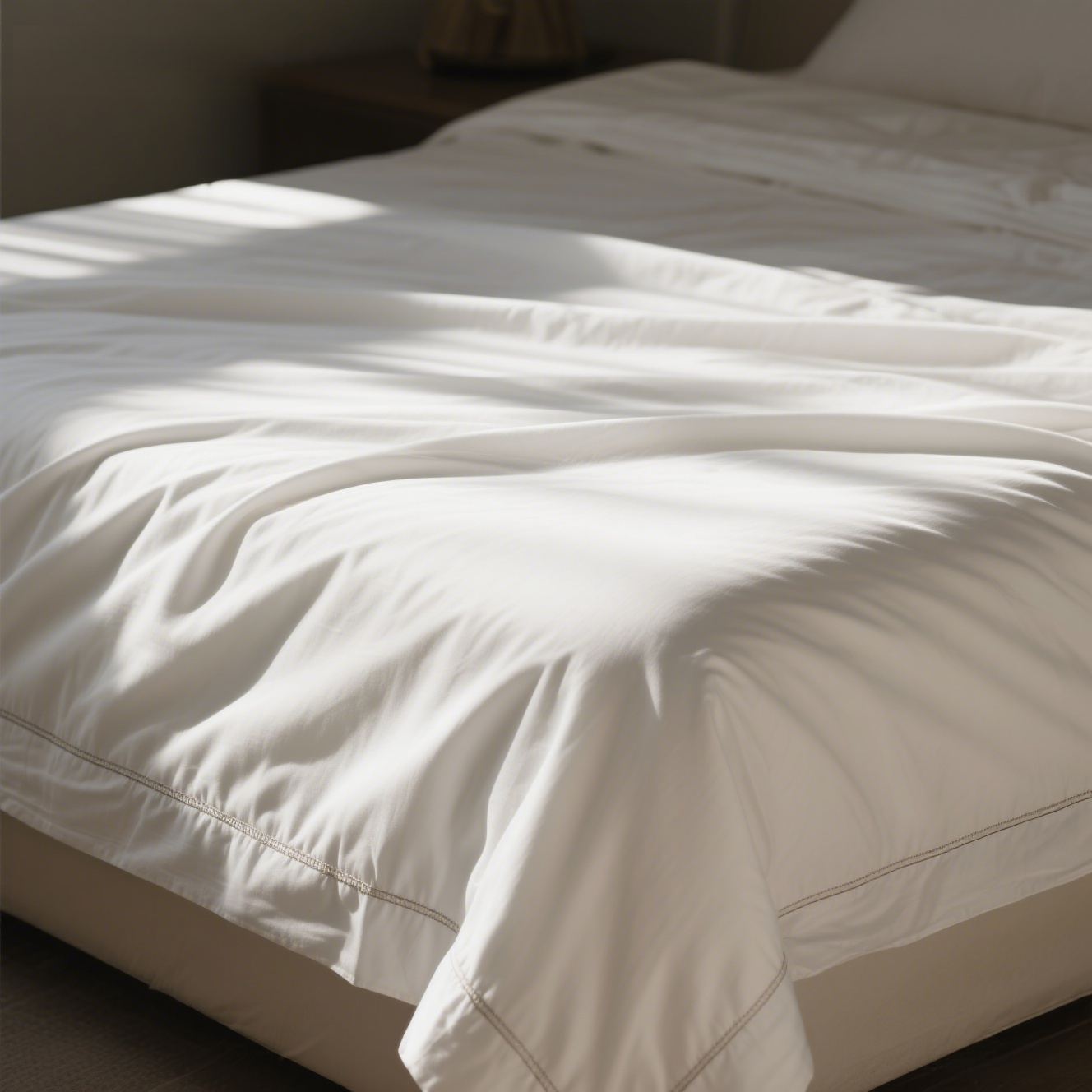 Soft cotton sheets on a neatly made bed