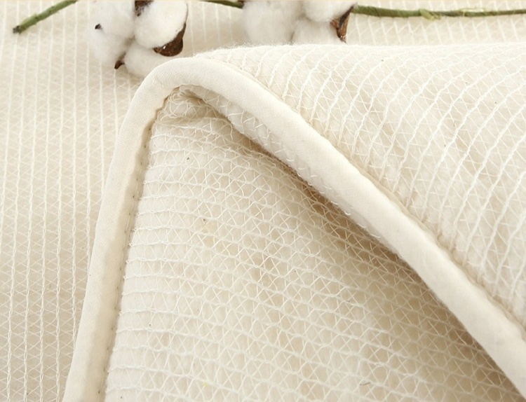 Woman enjoying warmth under insulation cotton quilt