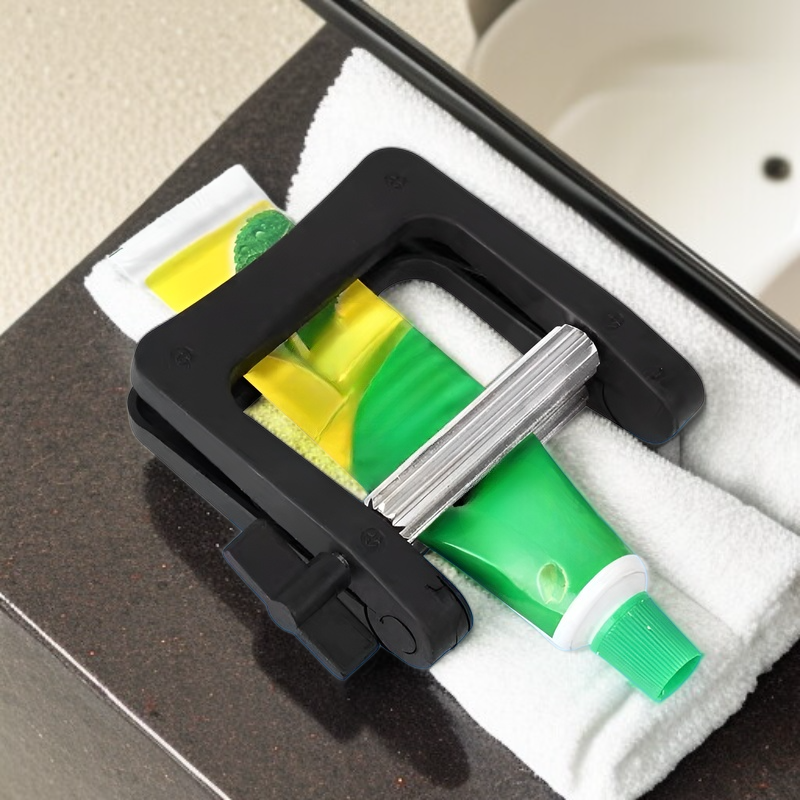 Stainless steel manual toothpaste squeezer in use