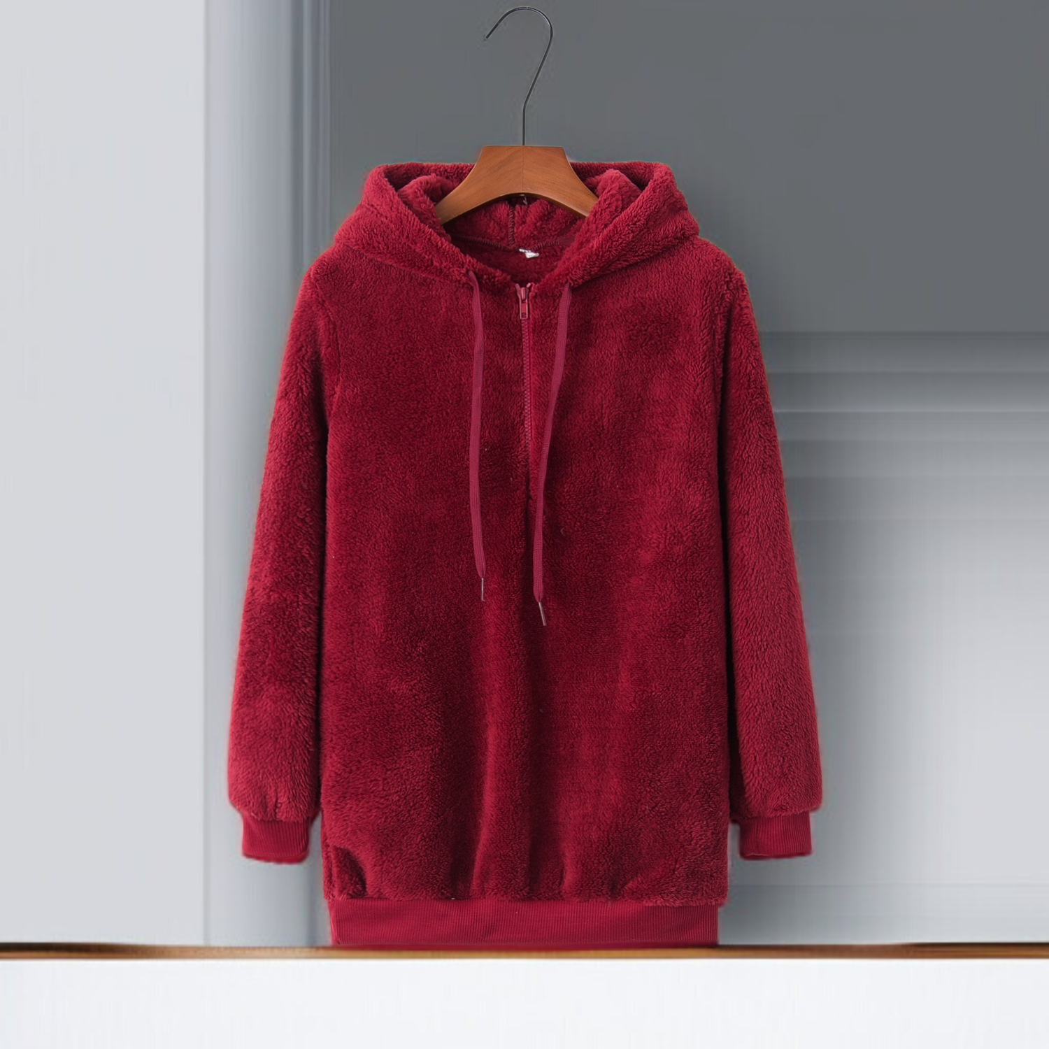 Detail of hood and drawstrings on women's fleece sweatshirt