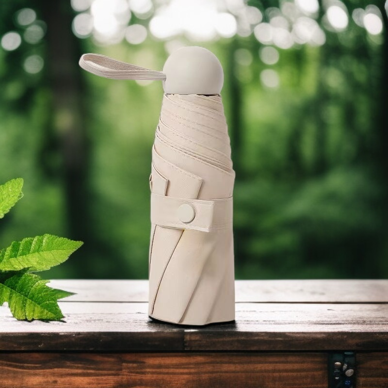 Compact foldable capsule umbrella suitable for both sunny and rainy days.