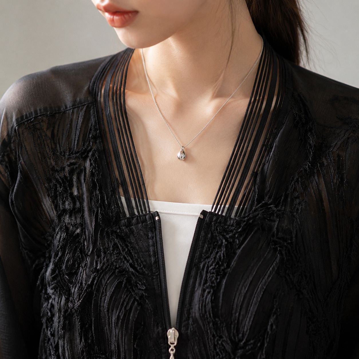 女性らしいシルエットのシースルーレーストップス