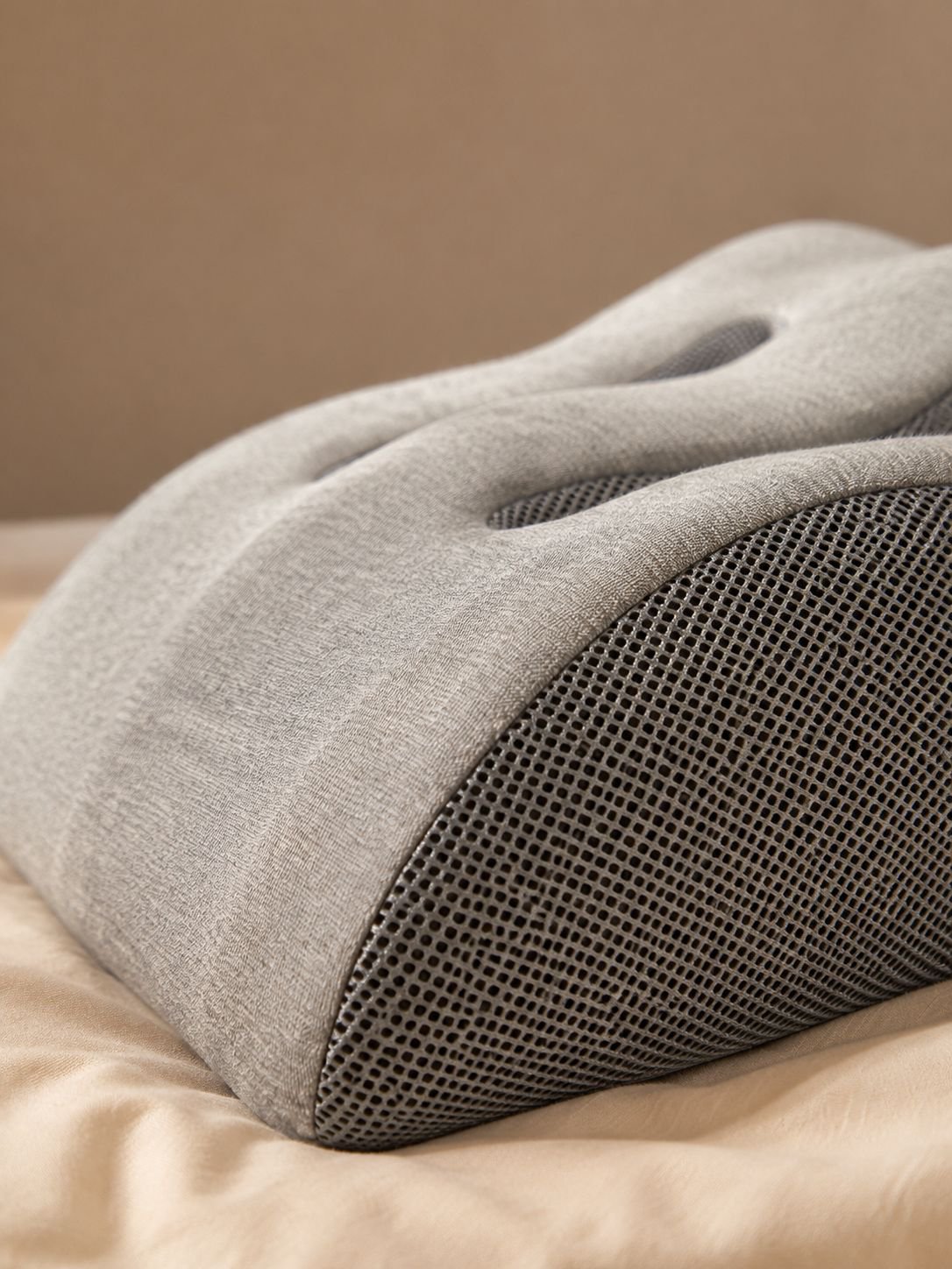 Leg support pillow placed on a bed for comfortable elevation