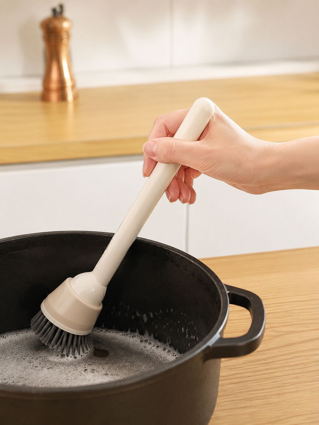 Pot brush with long handle reaching deep pots