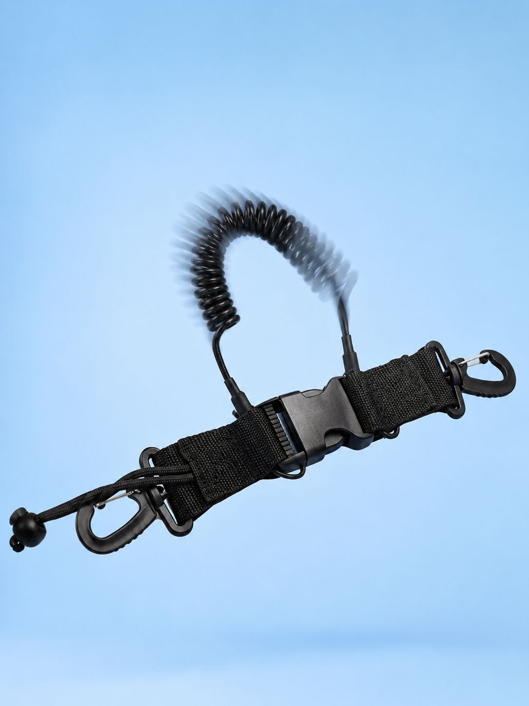 Quick-release clip attaching a camera tether to a BCD
