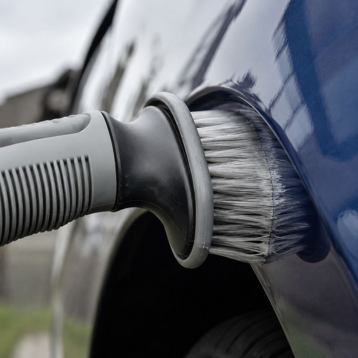 Soft fiber car tire and wheel cleaning brush in use