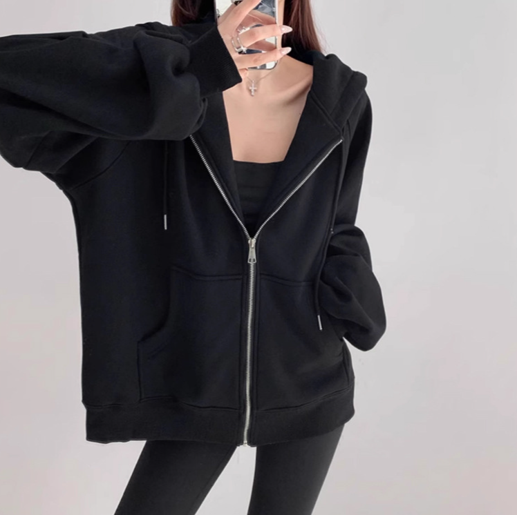 モデルがパーカーを着て屋外でポーズ