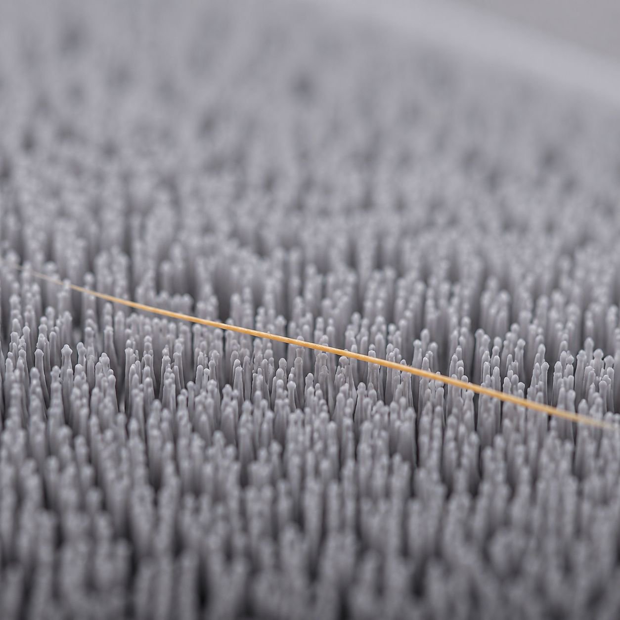 Hand using dust and hair remover on black jacket