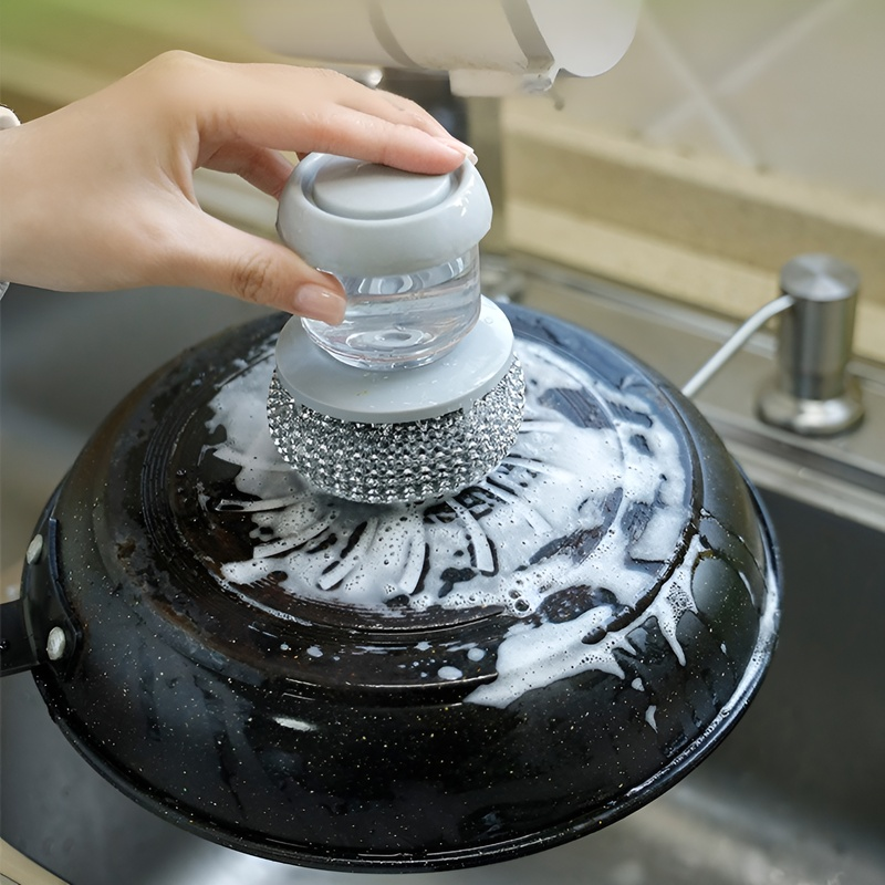 Ergonomic dish brush with soap dispenser and sponge head